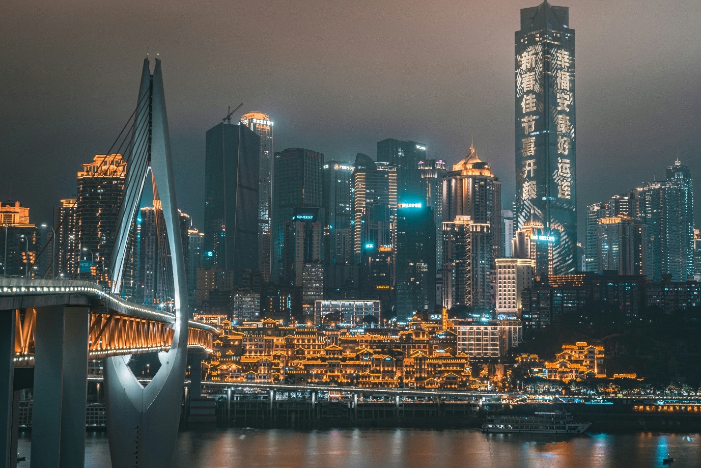 Chongqing skyline and river bridge at night