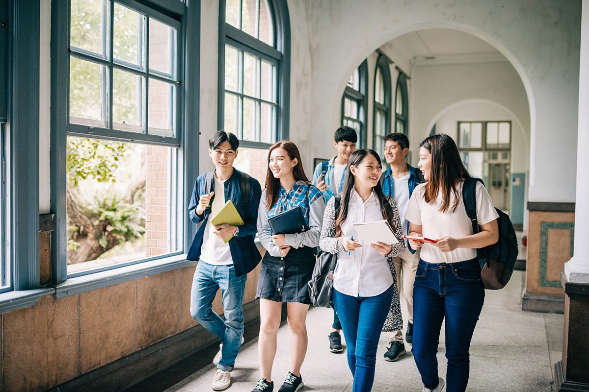 International students talking in a campus corridor